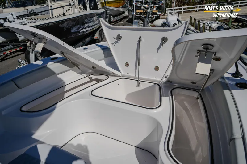 Slide: The Image of 2025 Blackfin 262 HB boat storage compartments open at a dealership. - 29