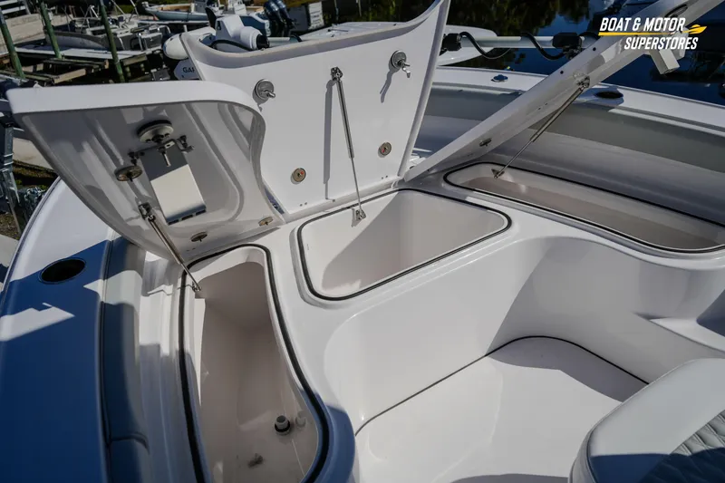 Slide: The Image of 2025 Blackfin 262 HB boat storage compartments open, showcasing spacious interior design. - 30