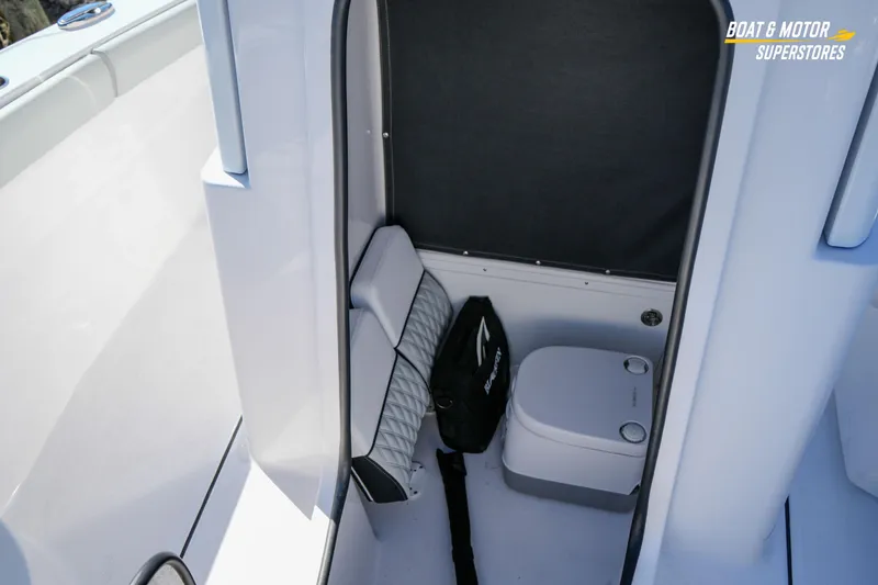 Slide: The Image of 2025 Blackfin 262 HB boat interior with compact marine toilet and storage area. - 33