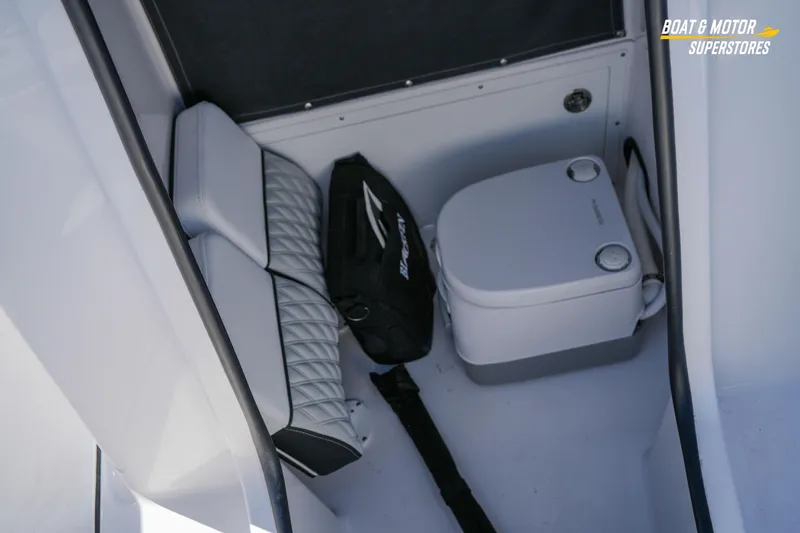 Slide: The Image of 2025 Blackfin 262 HB boat interior with portable toilet and storage area. - 34