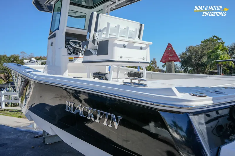 Slide: The Image of 2025 Blackfin 262 HB boat with sleek black hull, showcased outdoors. - 5