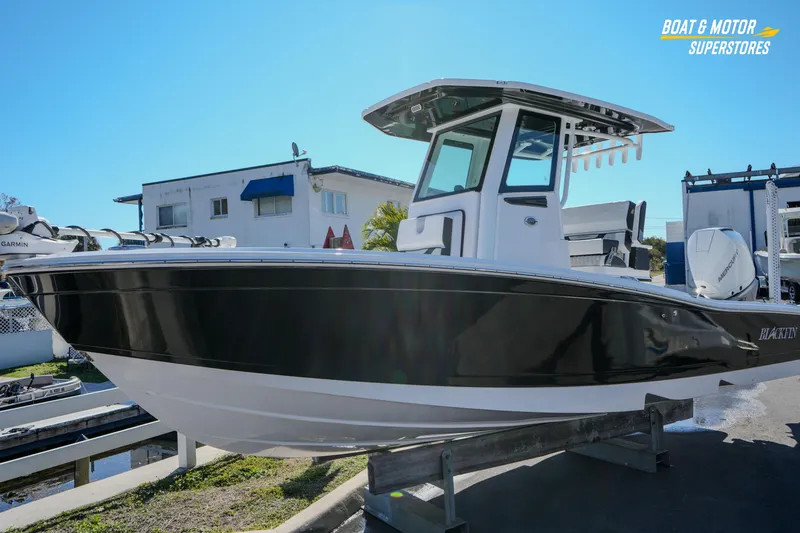 Slide: The Image of 2025 Blackfin 262 HB boat displayed outdoors at a dealership. - 9