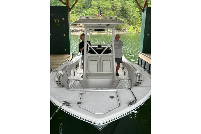 Slide: The Image of 2023 Sea Fox 248 Commander boat docked with two people onboard. - 13