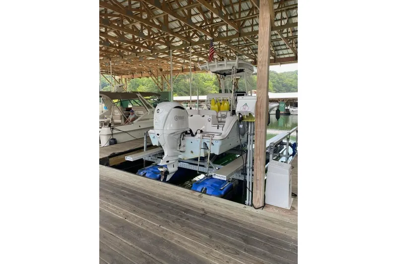 Slide: The Image of 2023 Sea Fox 248 Commander docked under a covered marina with Yamaha outboard. - 15