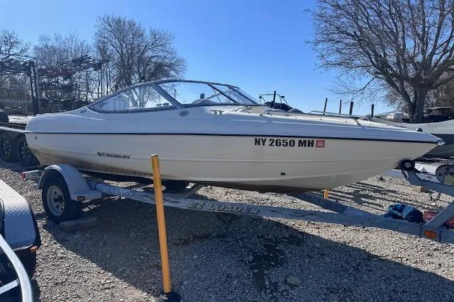 The Image of 2011 Stingray 185 LS/LX boat on trailer, parked outdoors. - 0
