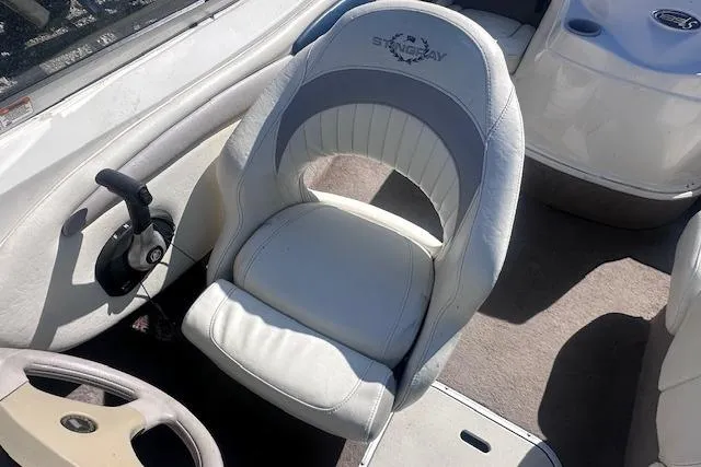 Slide: The Image of 2011 Stingray 185 LS/LX boat interior with white captain's chair and steering wheel. - 10