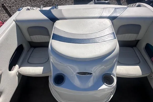 Slide: The Image of 2011 Stingray 185 LS/LX boat interior with white and blue seating and cup holders. - 12
