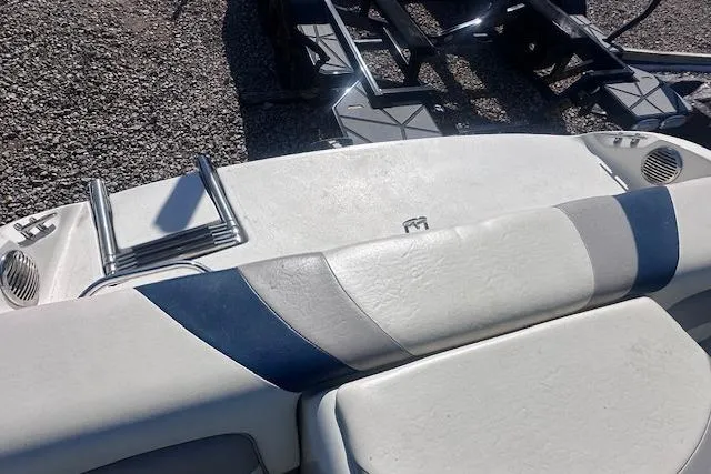 Slide: The Image of 2011 Stingray 185 LS/LX boat interior with white and blue seating, ladder, and speakers. - 13