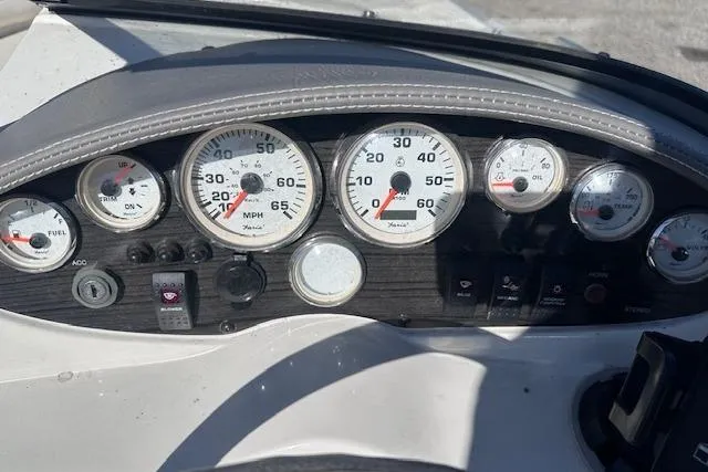 Slide: The Image of Dashboard of a 2011 Stingray 185 LS/LX boat with various gauges and controls. - 15