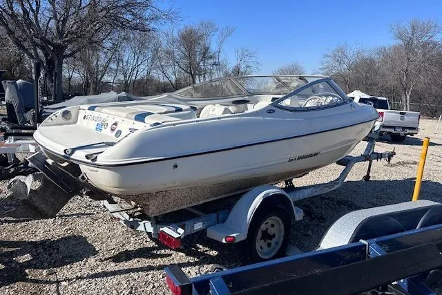 Slide: The Image of 2011 Stingray 185 LS/LX boat on trailer, parked outdoors on gravel. - 3
