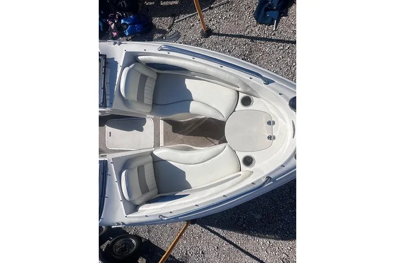 Slide: The Image of 2011 Stingray 185 LS/LX boat interior with white seating and gray flooring. - 8