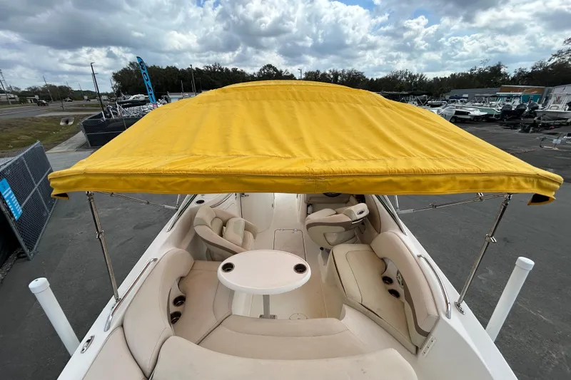 Slide: The Image of 2006 Chaparral Sunesta 236 boat with yellow canopy and spacious seating area. - 100