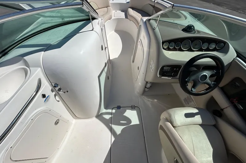 Slide: The Image of 2006 Chaparral Sunesta 236 boat interior with steering wheel and dashboard controls. - 13