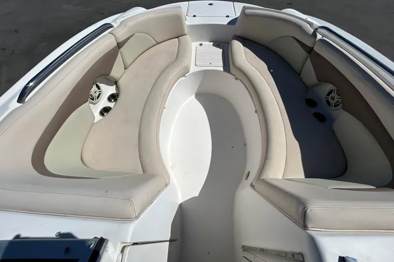 Slide: The Image of 2006 Chaparral Sunesta 236 boat interior with beige seating and built-in speakers. - 14