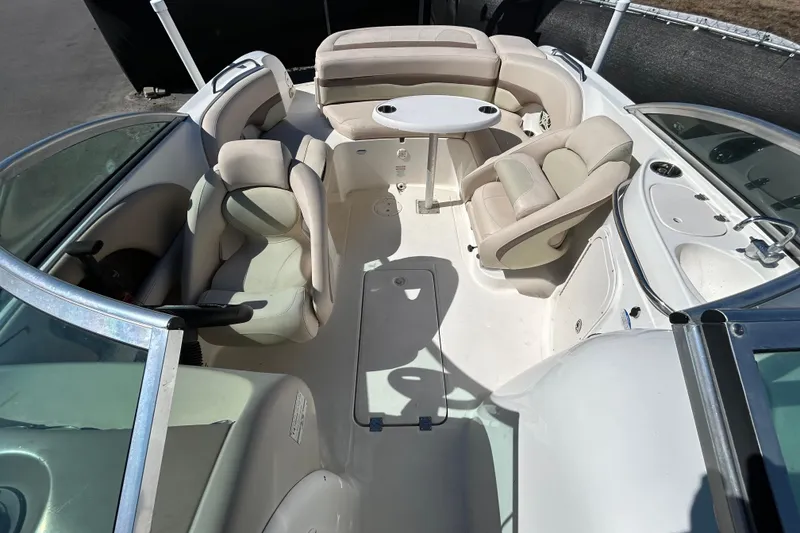 Slide: The Image of 2006 Chaparral Sunesta 236 boat interior with seating and table, showcasing spacious design. - 18