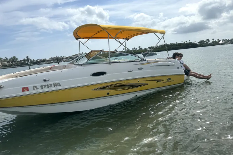 Slide: The Image of 2006 Chaparral Sunesta 236 boat on trailer, yellow and white design, clear blue sky. - 2