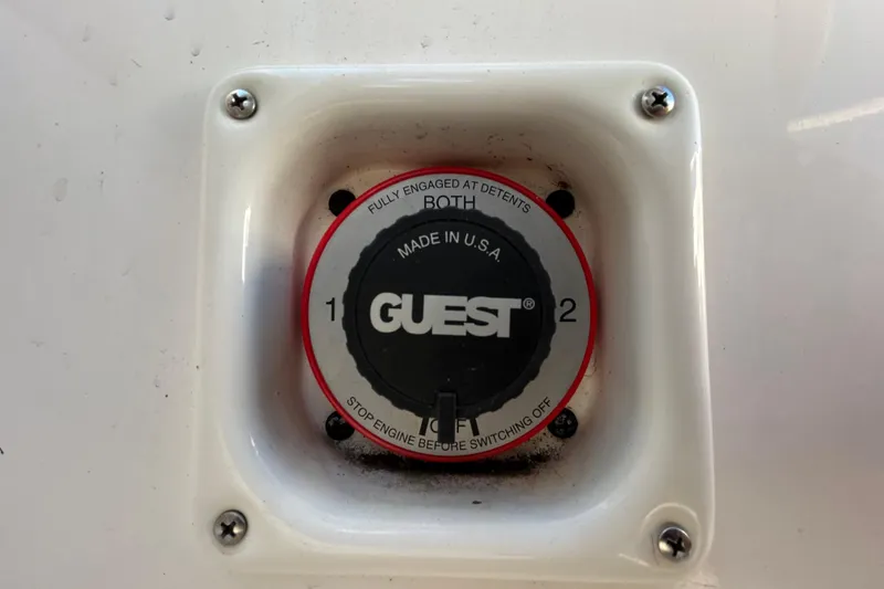Slide: The Image of Battery switch on a 2006 Chaparral Sunesta 236 boat, labeled "Guest." - 22