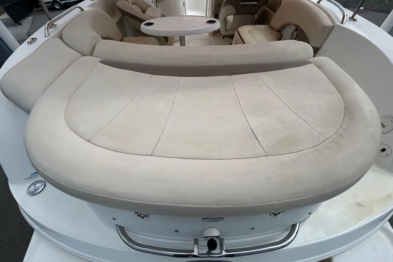 Slide: The Image of 2006 Chaparral Sunesta 236 boat interior with beige seating and table. - 36