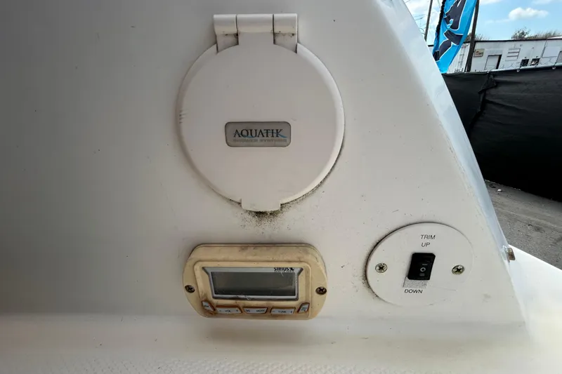 Slide: The Image of 2006 Chaparral Sunesta 236 boat controls with Aquatik shower system and trim switch. - 38