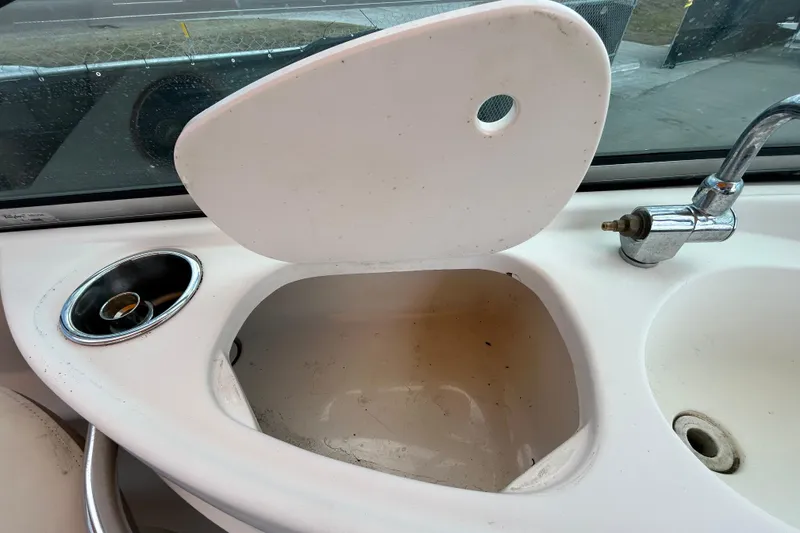 Slide: The Image of 2006 Chaparral Sunesta 236 boat sink with faucet and cup holder. - 54