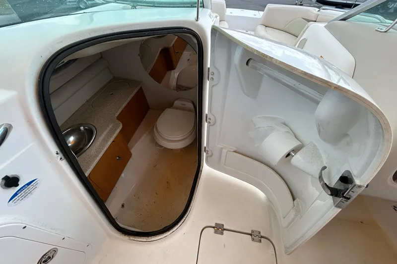 Slide: The Image of 2006 Chaparral Sunesta 236 boat interior with compact bathroom and sink. - 57