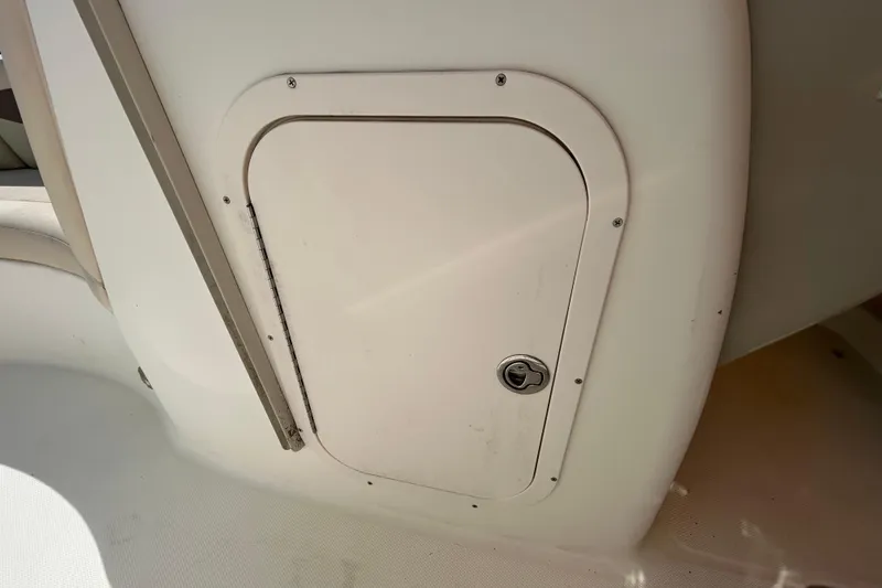 Slide: The Image of 2006 Chaparral Sunesta 236 boat storage compartment with lock, interior view. - 59