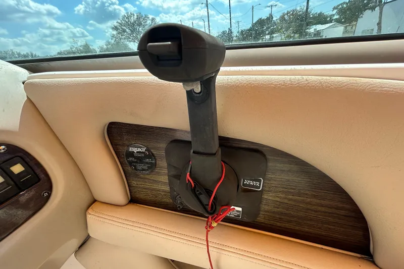 Slide: The Image of 2006 Chaparral Sunesta 236 throttle control with beige interior and wood accents. - 63