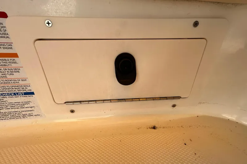 Slide: The Image of 2006 Chaparral Sunesta 236 boat compartment with checklist and hinge details. - 64