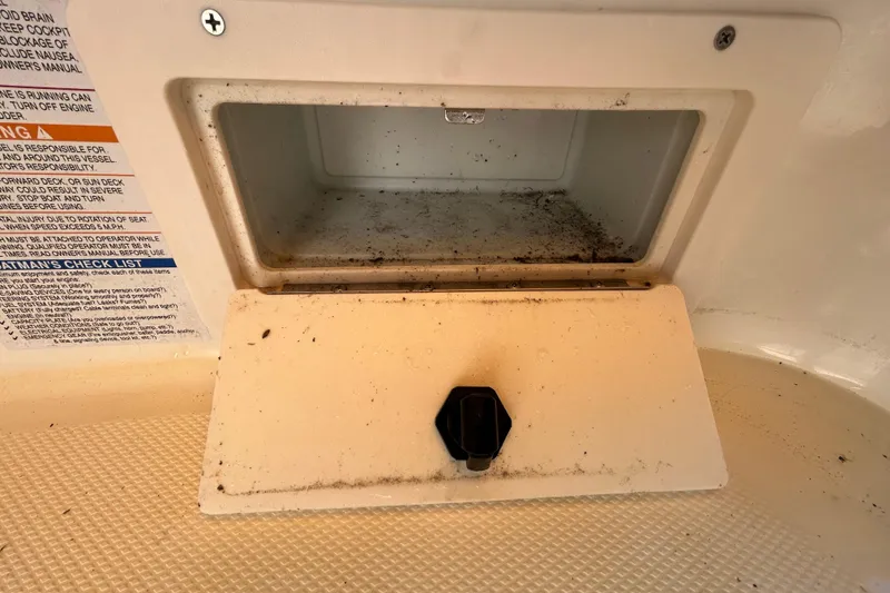 Slide: The Image of Storage compartment in a 2006 Chaparral Sunesta 236 boat, showing interior and safety instructions. - 65