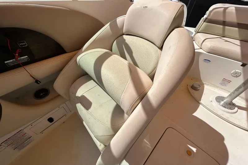 Slide: The Image of 2006 Chaparral Sunesta 236 boat interior with beige seating and console details. - 67