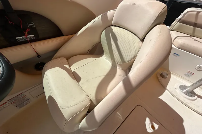 Slide: The Image of 2006 Chaparral Sunesta 236 boat seat, beige upholstery, sunlight casting shadows. - 68
