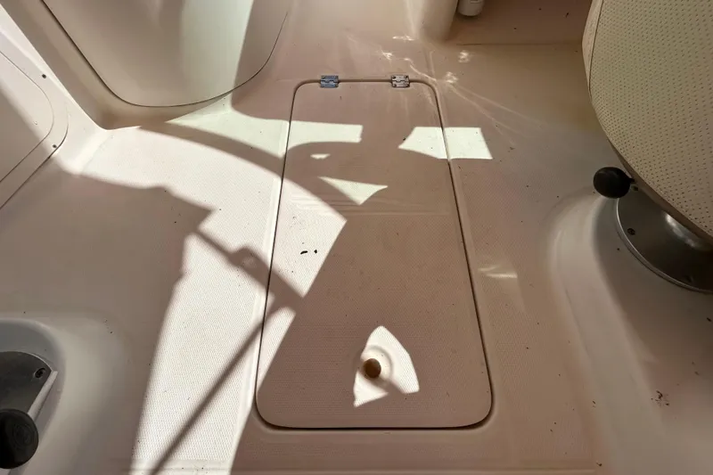 Slide: The Image of 2006 Chaparral Sunesta 236 boat interior with storage compartment and seating. - 70