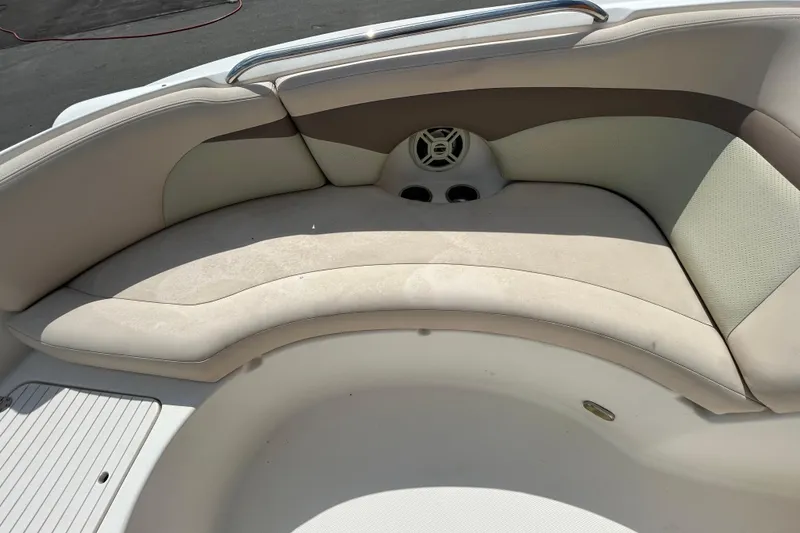 Slide: The Image of 2006 Chaparral Sunesta 236 boat interior with beige seating and cup holders. - 73