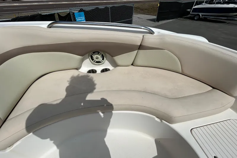 Slide: The Image of 2006 Chaparral Sunesta 236 boat interior with beige seating and cup holders. - 83
