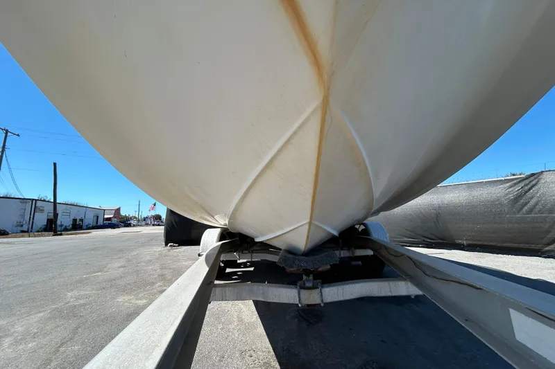 Slide: The Image of 2006 Chaparral Sunesta 236 boat on trailer, viewed from below, outdoors. - 86