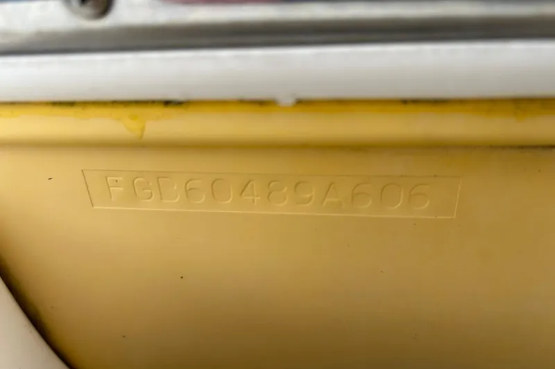 Slide: The Image of 2006 Chaparral Sunesta 236 hull identification number (HIN) on yellow surface. - 90