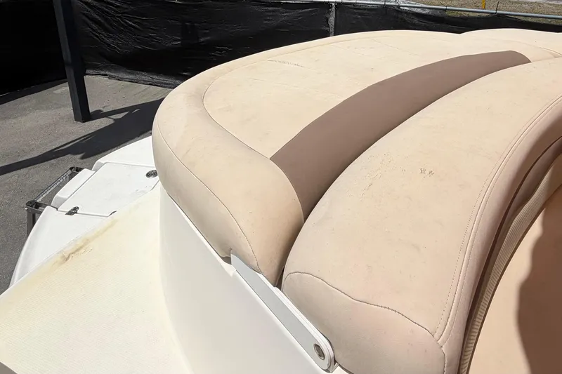 Slide: The Image of 2006 Chaparral Sunesta 236 boat seat with beige upholstery in sunlight. - 93