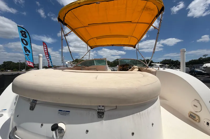 Slide: The Image of 2006 Chaparral Sunesta 236 boat with yellow canopy, displayed outdoors under blue sky. - 94