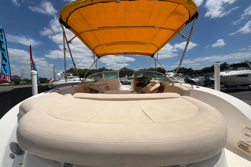 Slide: The Image of 2006 Chaparral Sunesta 236 boat with yellow canopy, spacious seating, and clear skies. - 95