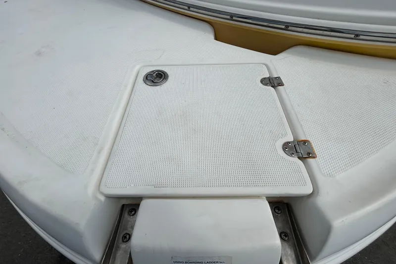 Slide: The Image of 2006 Chaparral Sunesta 236 boat deck with hatch and metal hinges. - 96