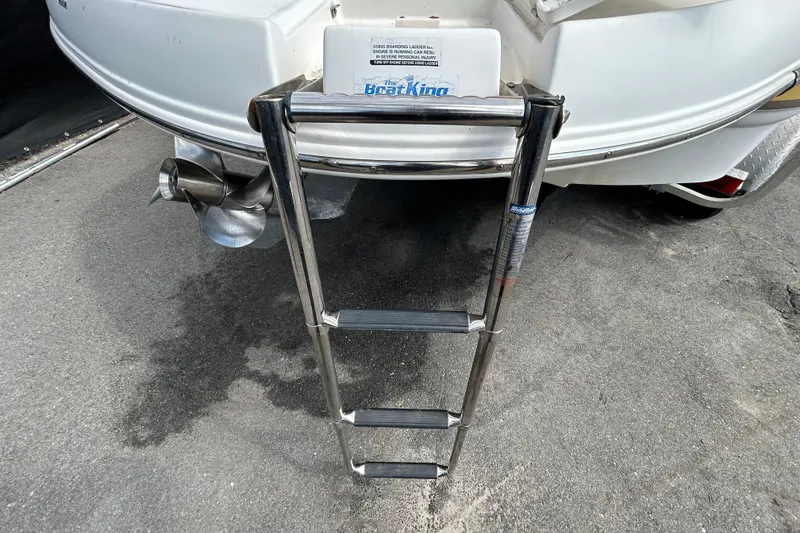 Slide: The Image of 2006 Chaparral Sunesta 236 boat with extended swim ladder and propeller detail. - 98