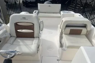 Slide: The Image of 2023 Cobia 220 Dual Console boat interior with white seating and modern design. - 11