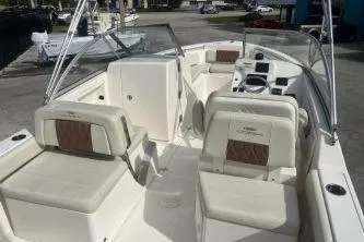 Slide: The Image of 2023 Cobia 220 Dual Console boat interior with seating and dashboard. - 7