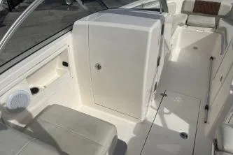 Slide: The Image of 2023 Cobia 220 Dual Console boat interior with seating and storage compartments. - 9