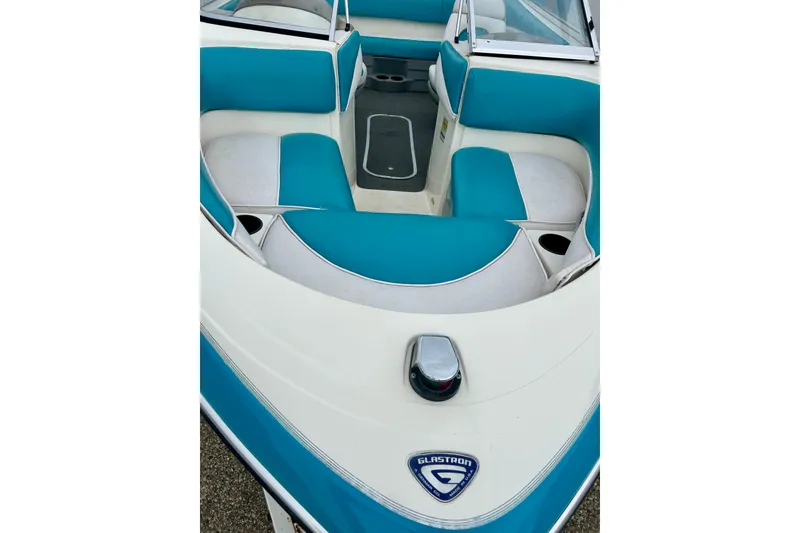 Slide: The Image of 1993 Glastron SSV 175 boat interior with teal and white seating. - 2