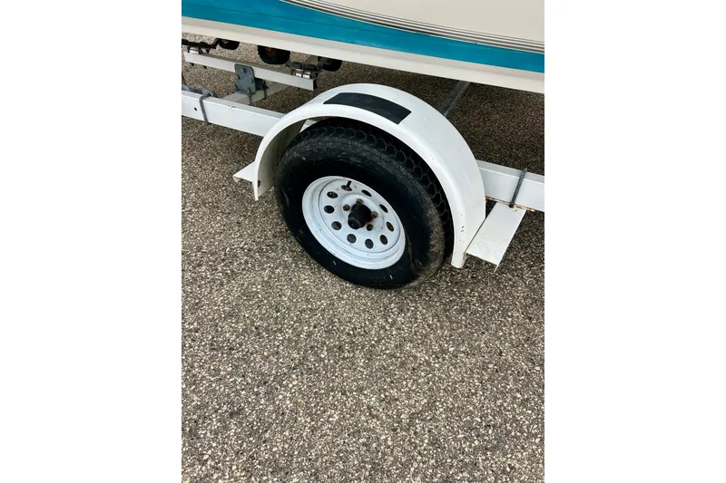 Slide: The Image of Trailer wheel of 1993 Glastron SSV 175 boat on asphalt surface. - 3