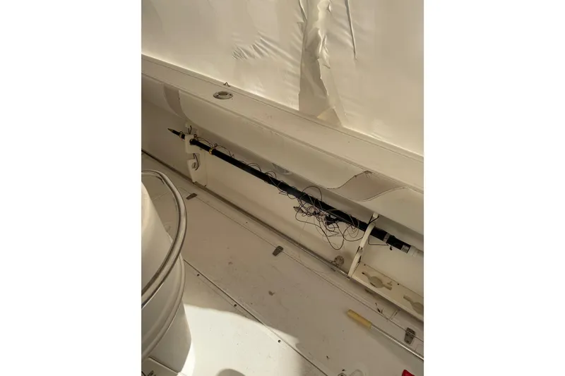Slide: The Image of Interior view of a 2004 Boston Whaler 320 Outrage boat, showing storage compartment. - 12