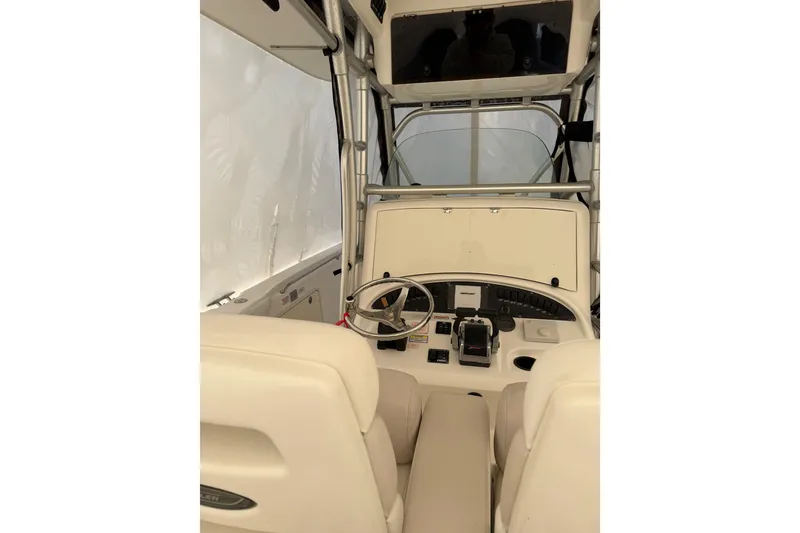 Slide: The Image of Interior view of 2004 Boston Whaler 320 Outrage boat cockpit with steering wheel and controls. - 13