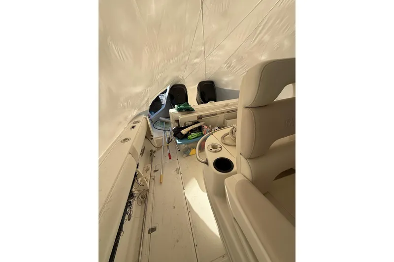 Slide: The Image of Interior view of a 2004 Boston Whaler 320 Outrage boat under cover. - 17