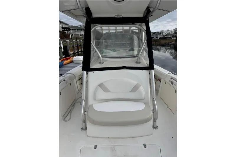 Slide: The Image of 2004 Boston Whaler 320 Outrage boat interior with seating and console view. - 2
